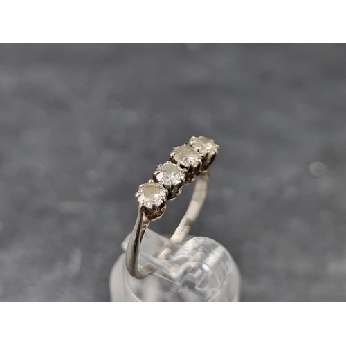 137 - An Edwardian white metal and diamond four stone ring, stamped '18ct/Plat', size L 1/2.... 