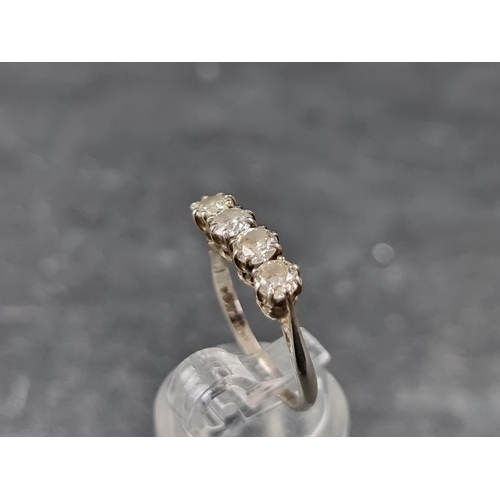 137 - An Edwardian white metal and diamond four stone ring, stamped '18ct/Plat', size L 1/2.... 