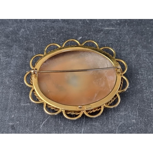 208 - A carved shell cameo brooch, in a yellow metal mount, stamped '9ct', the outer frame 61 x 51mm.... 