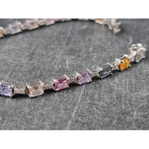 240 - A white metal multicoloured sapphire and diamond set bracelet, stamped 750, having twenty octagonal ... 