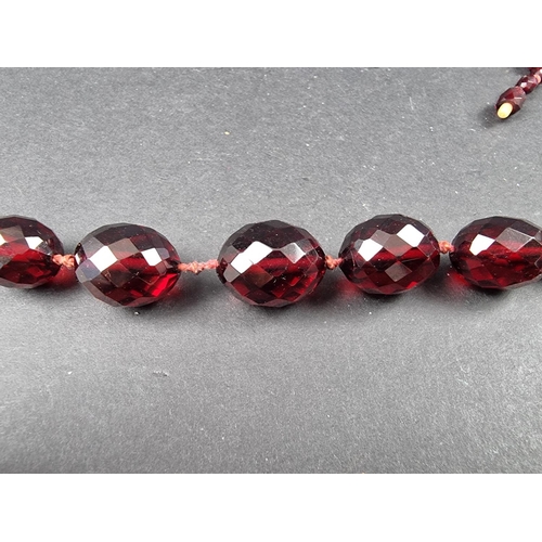 322 - A cherry amber style faceted bead necklace, having seventy three beads of approximately 5-16mm diame... 