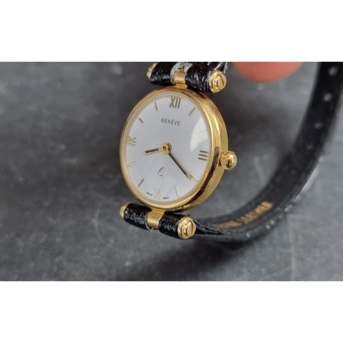 366 - A set of two similar Geneve 9ct gold quartz wristwatches, largest 32mm, both on black leather straps... 