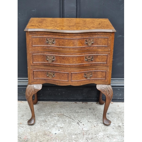 1002 - A small reproduction burr walnut serpentine fronted chest of drawers, on cabriole legs, 61.5cm wide.... 