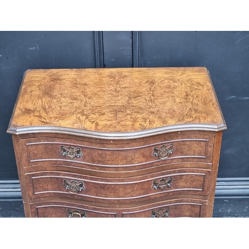 1002 - A small reproduction burr walnut serpentine fronted chest of drawers, on cabriole legs, 61.5cm wide.... 