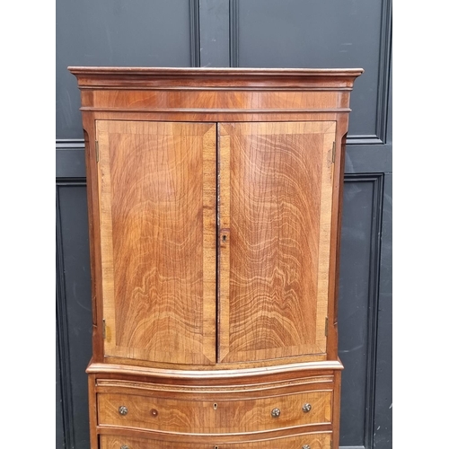 1006 - A reproduction mahogany serpentine fronted side cabinet, 70cm wide.