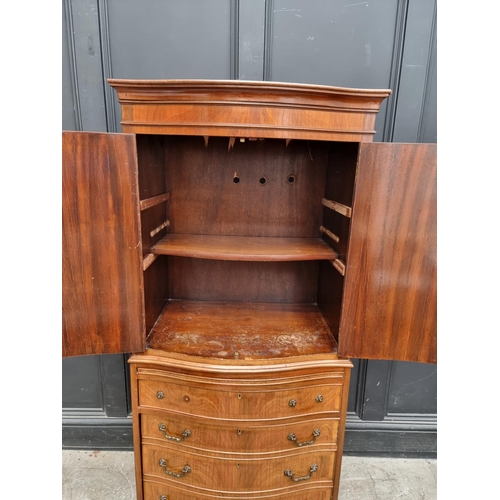 1006 - A reproduction mahogany serpentine fronted side cabinet, 70cm wide.