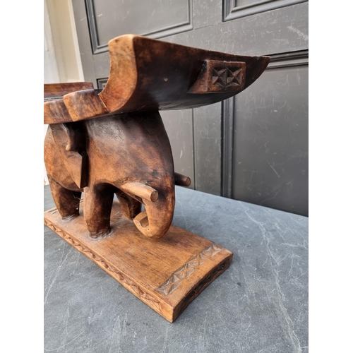 1008 - Ethnographica: a carved hardwood elephant stool, 50cm wide.