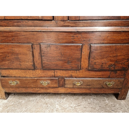 1010 - An 18th century oak panelled press cupboard, 138cm wide.