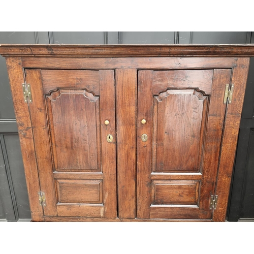 1010 - An 18th century oak panelled press cupboard, 138cm wide.