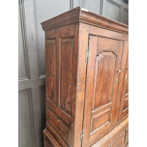 1010 - An 18th century oak panelled press cupboard, 138cm wide.