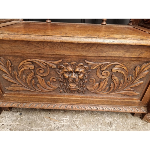 1015 - A late Victorian carved oak box seat settle, 109.5cm wide.