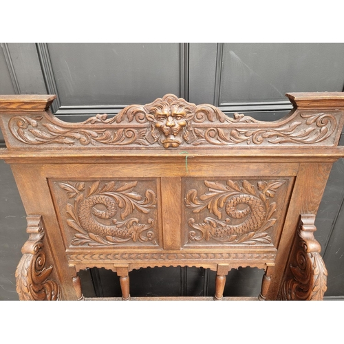 1015 - A late Victorian carved oak box seat settle, 109.5cm wide.