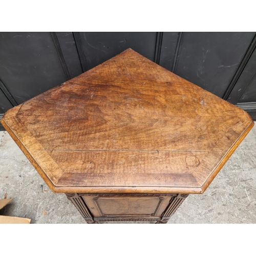 1017 - An unusual antique continental walnut corner cupboard, 88cm wide.