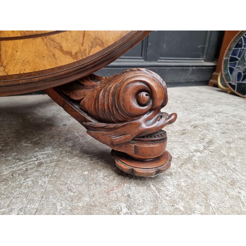 1020 - A good Victorian figured walnut oval loo table, with dolphin base, 152cm wide.