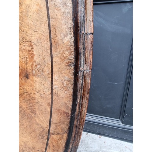 1020 - A good Victorian figured walnut oval loo table, with dolphin base, 152cm wide.