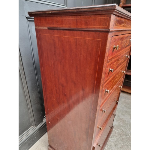 1021 - A late Victorian mahogany and inlaid Wellington chest, in the manner of Edwards & Roberts, ... 