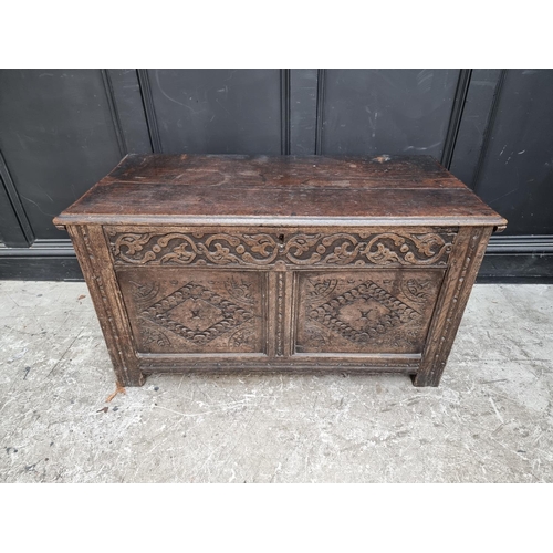 1027 - A late 17th century carved oak panelled coffer, 106.5cm wide.