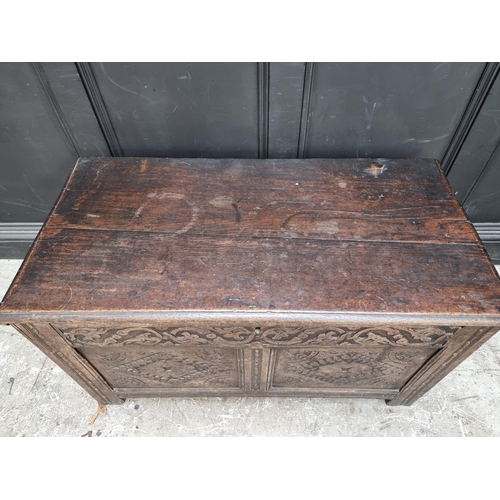 1027 - A late 17th century carved oak panelled coffer, 106.5cm wide.