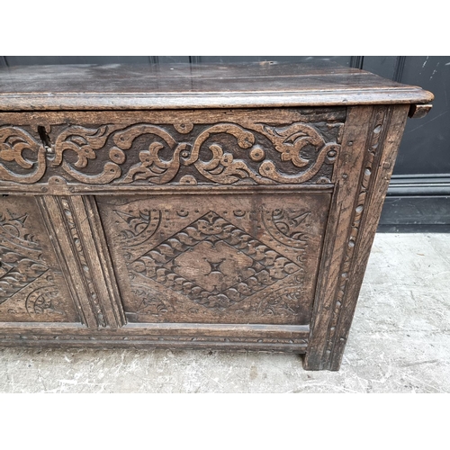 1027 - A late 17th century carved oak panelled coffer, 106.5cm wide.