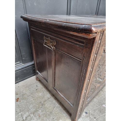 1027 - A late 17th century carved oak panelled coffer, 106.5cm wide.