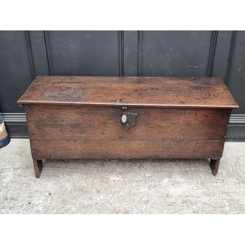 1034 - A late 17th century oak boarded coffer, 122cm wide.