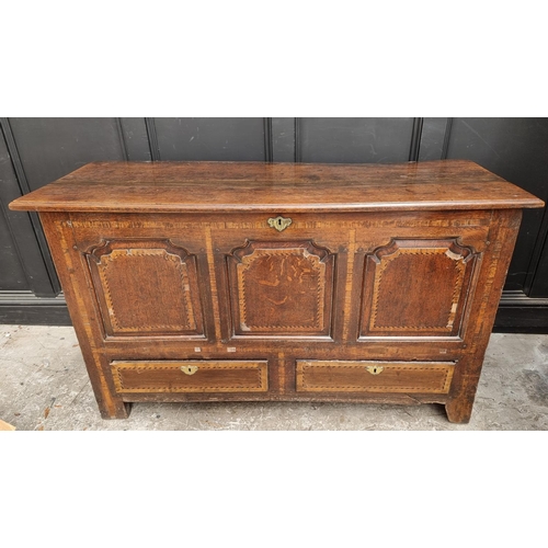 1035 - An 18th century oak and inlaid panelled mule chest, 147.5cm wide.