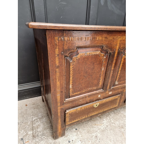 1035 - An 18th century oak and inlaid panelled mule chest, 147.5cm wide.