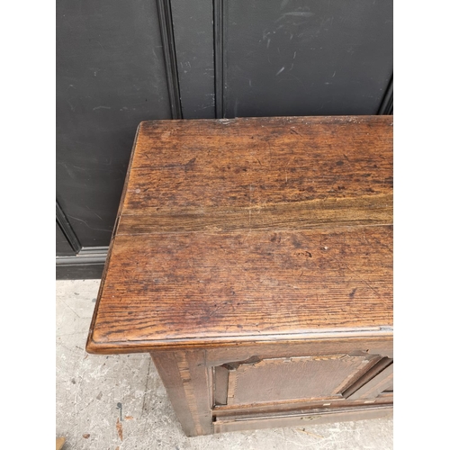 1035 - An 18th century oak and inlaid panelled mule chest, 147.5cm wide.