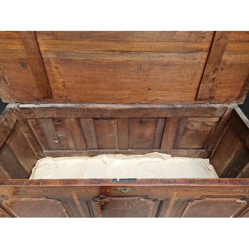 1035 - An 18th century oak and inlaid panelled mule chest, 147.5cm wide.