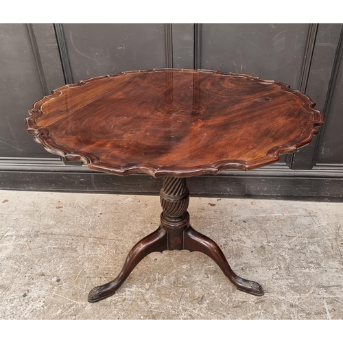 1036 - A George III mahogany piecrust tilt top tripod table, 86cm wide.