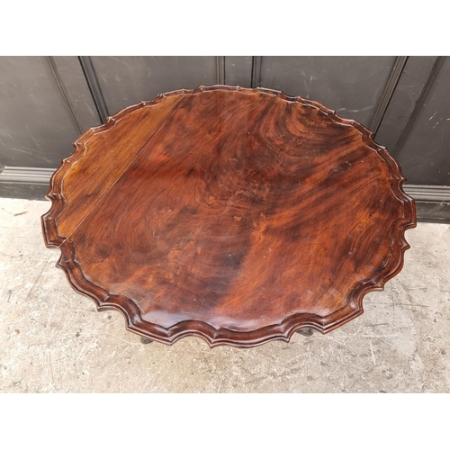 1036 - A George III mahogany piecrust tilt top tripod table, 86cm wide.