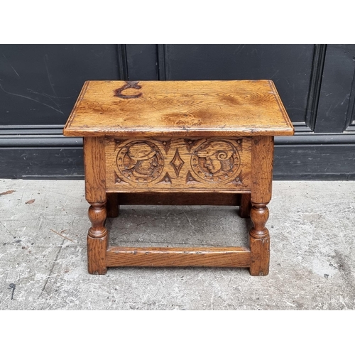 1037 - A 17th century style carved oak box seat joint stool, the frieze decorated with two Romayne hea... 