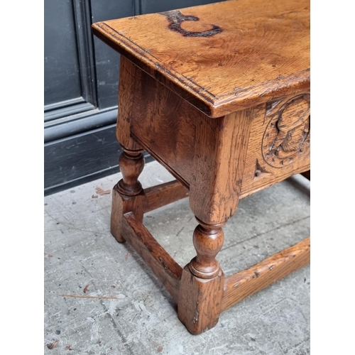 1037 - A 17th century style carved oak box seat joint stool, the frieze decorated with two Romayne hea... 