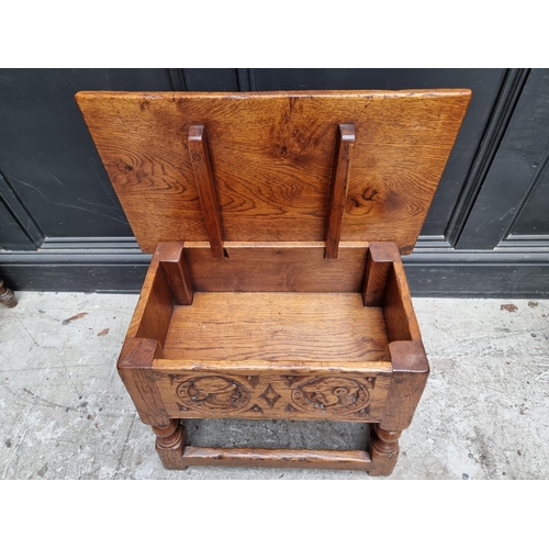 1037 - A 17th century style carved oak box seat joint stool, the frieze decorated with two Romayne hea... 