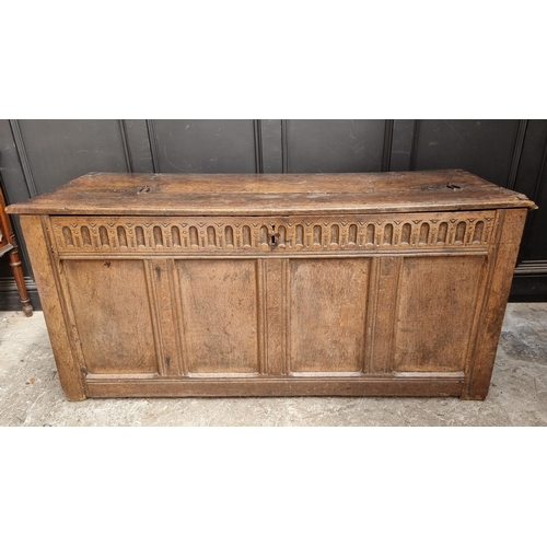 1038 - A large late 17th century oak panelled coffer, 162cm wide, (old alterations to top).... 