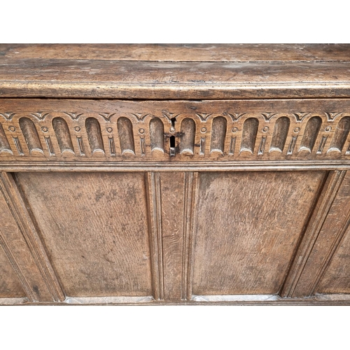 1038 - A large late 17th century oak panelled coffer, 162cm wide, (old alterations to top).... 