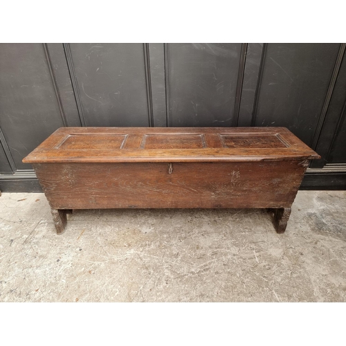 1039 - An unusual 17th century elm and oak boarded coffer, of tapered profile, 152.5cm wide.... 