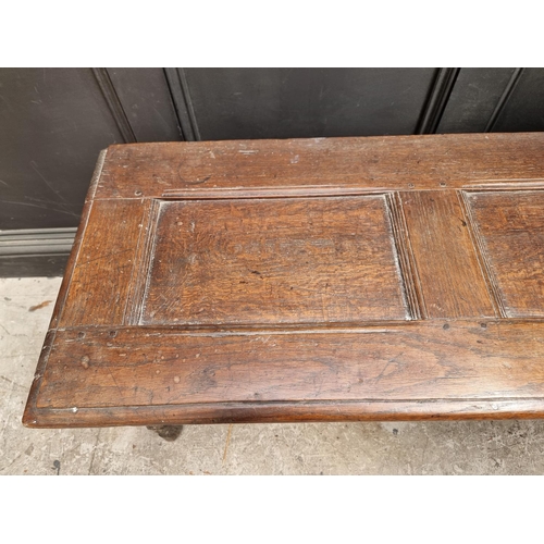 1039 - An unusual 17th century elm and oak boarded coffer, of tapered profile, 152.5cm wide.... 