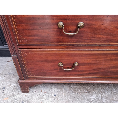 1044 - A George III mahogany and line inlaid chest of drawers, 133cm wide.