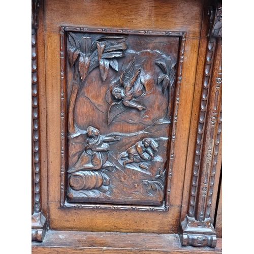 1046 - A large late 19th century Flemish carved oak sideboard, 164cm wide.