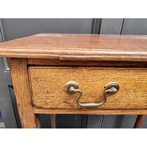 1047 - A George III oak single drawer side table, 66cm wide.