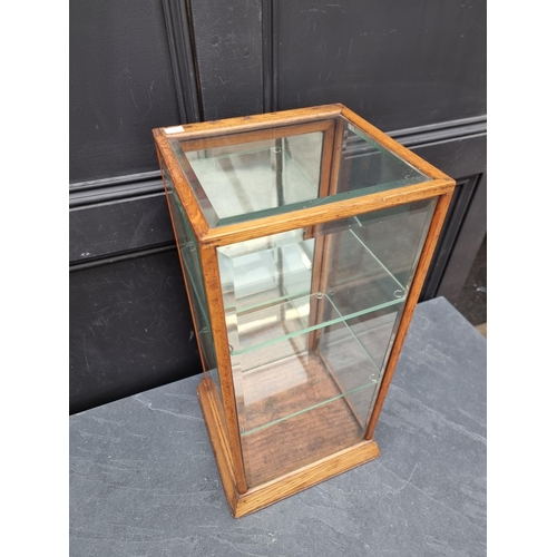 1049 - A small antique oak and bevelled glass table top display case, 62cm high x 31cm wide x 29.5cm d... 