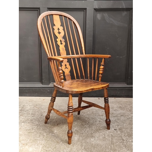 1056 - A Victorian ash, elm and fruitwood highback Windsor armchair.