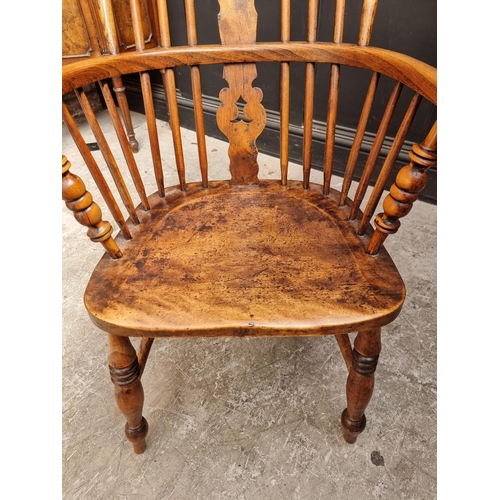 1056 - A Victorian ash, elm and fruitwood highback Windsor armchair.