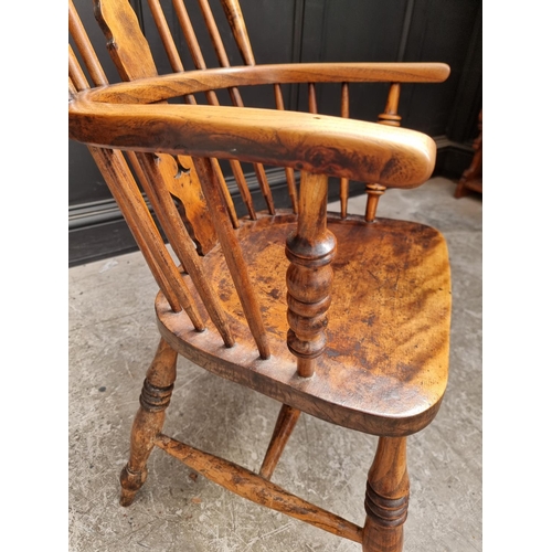 1056 - A Victorian ash, elm and fruitwood highback Windsor armchair.