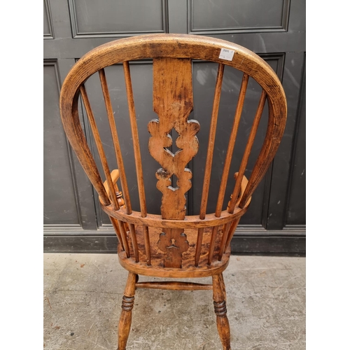 1056 - A Victorian ash, elm and fruitwood highback Windsor armchair.