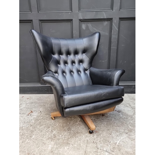 1062 - A mid-century G Plan black vinyl 'Blofeld' swivel armchair and matching stool.