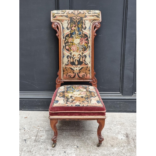 1063 - A Victorian walnut and petit point prie dieu chair.