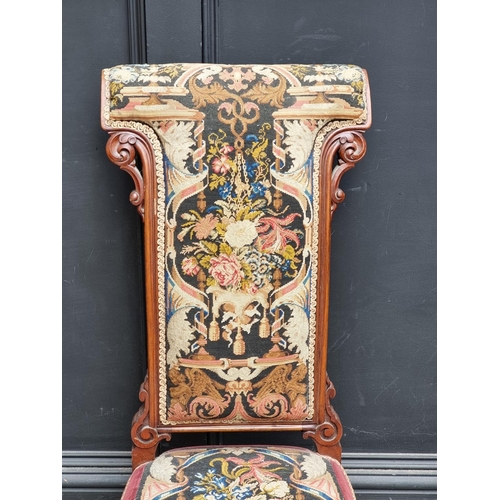 1063 - A Victorian walnut and petit point prie dieu chair.