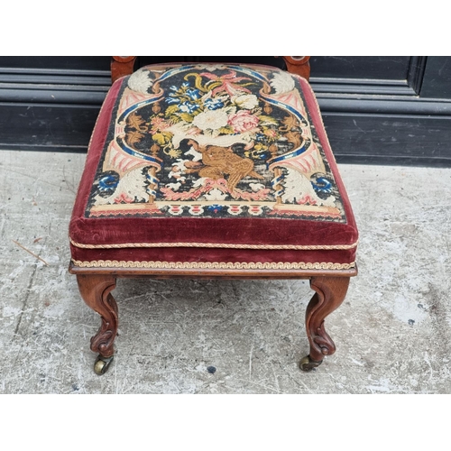 1063 - A Victorian walnut and petit point prie dieu chair.